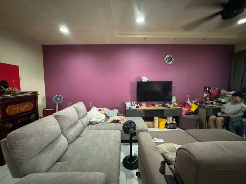 Living features: grey fabric sectional sofa, coffee table, wall-mounted TV, purple accent wall, white tiled flooring, ceiling fan, decorative wall clock, various decorative items on shelves, fan, cluttered surface with miscellaneous items; style: contemporary.