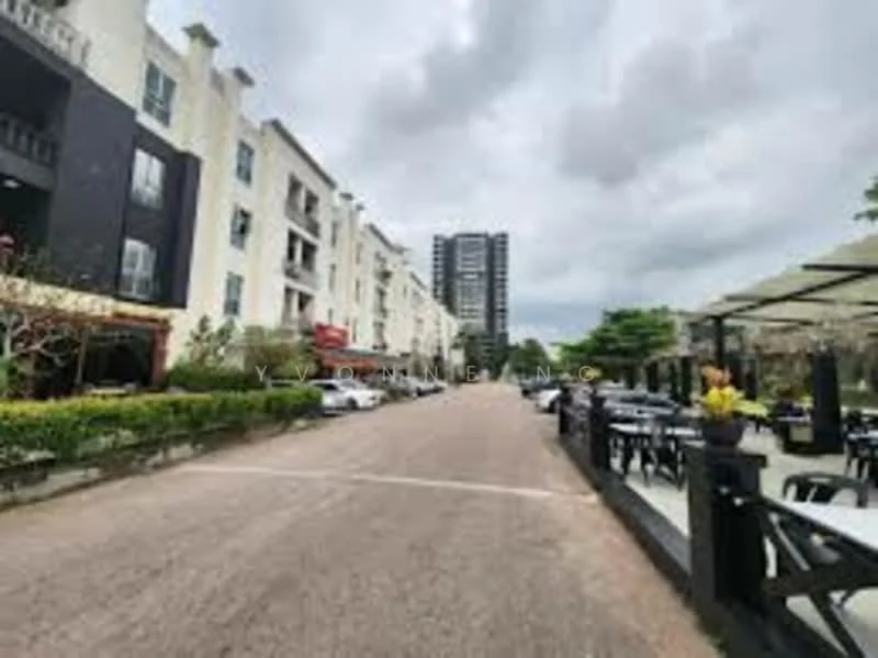 Exterior type: low-rise apartment block; features: white painted facade, black accent facade, manicured landscaping, outdoor dining area with tables and chairs, paved walkway, surrounded by greenery, multi-storey building in background, covered outdoor seating area; style: modern.