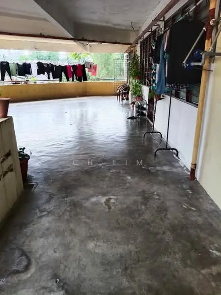 Room features: concrete flooring, exposed ceiling, laundry drying area, potted plants, clothes hanging on a line, open space, natural light, balcony railing; style: minimalist; view: garden.
