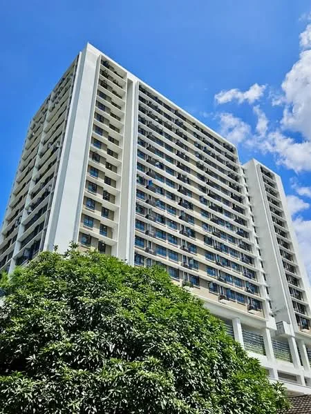 Exterior type: high-rise condominium; features: white painted facade, glass curtain wall, recessed balconies, approximately 10-storey high-rise, surrounded by mature greenery, large windows, modern architectural design; style: modern.