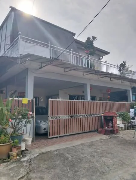 Exterior type: semi-detached house; features: two-storey structure, grey painted facade, balcony with railing, paved driveway, wooden gate, front garden with potted plants, car parked in driveway, decorative shrine, overhanging roof, mature trees in garden; style: modern.