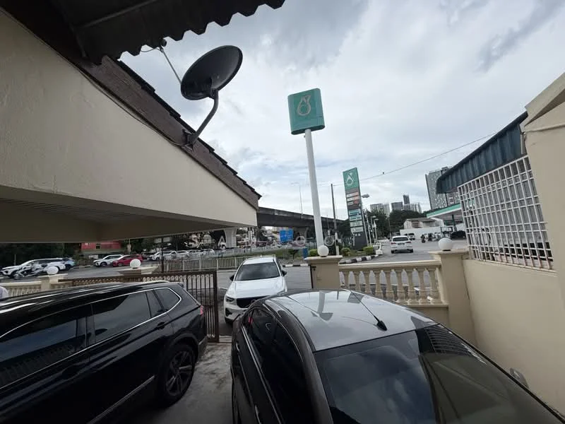 Exterior features: satellite dish, white painted facade, fenced perimeter, paved driveway, multiple parked cars, street view, signage visible, overcast sky; style: modern.