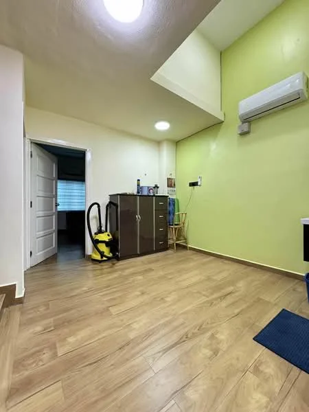 Room features: green painted walls, wooden flooring, 1 wall-mounted split AC, ceiling light, white door, brown storage cabinet, small wooden chair, vacuum cleaner, blue mat; style: modern.