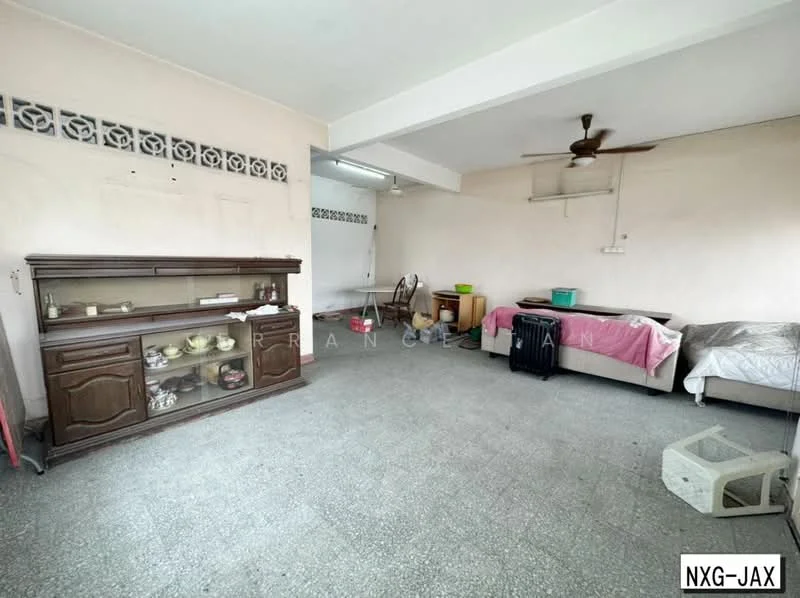 Room features: grey terrazzo flooring, white painted walls, ceiling fan, wooden sideboard, single bed with bedding, plastic storage boxes, luggage, open space layout.