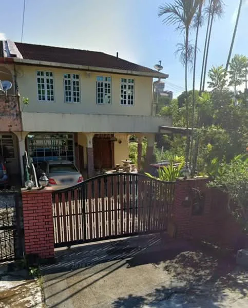 Exterior type: detached bungalow; features: red brick facade, two-storey building, gated entrance, manicured garden, paved driveway, multiple windows, roof with overhang, surrounded by greenery; style: traditional.