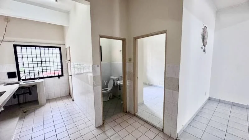 Room features: white painted walls, tile flooring, window with black metal grille, doorway leading to bathroom, doorway leading to another room, built-in desk area, ceramic tile cladding in bathroom, toilet visible in bathroom.
