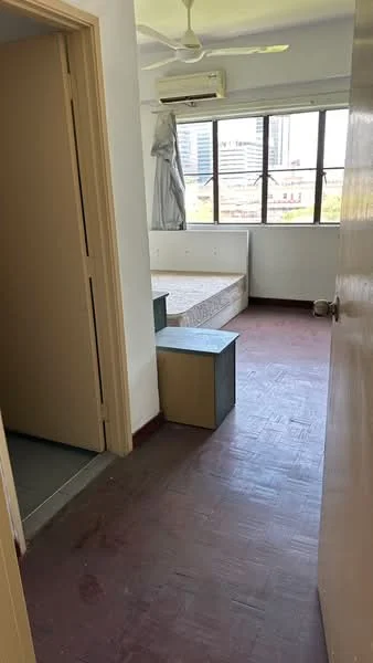 Room features: wooden flooring, white painted walls, ceiling fan, large windows, doorway leading to another room, bed frame without mattress, small storage box, natural light from windows; view: city.
