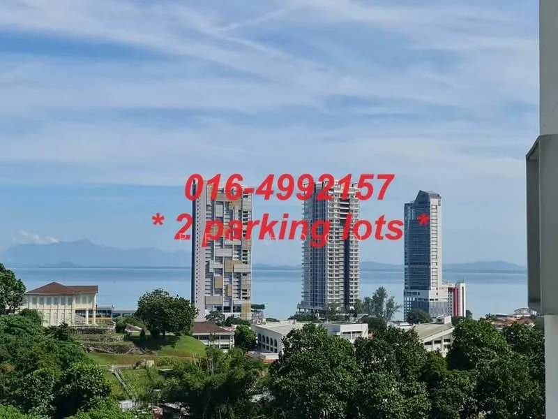 Exterior type: high-rise condominium; features: city skyline view, surrounded by greenery, two visible high-rise buildings, waterfront view, clear blue sky, urban context; style: modern.