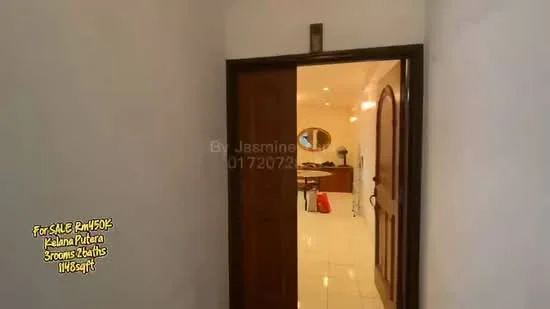 Room features: white painted walls, ceramic tile flooring, wooden door, arched doorways, recessed lighting, open layout, visible furniture in background, neutral color palette; style: modern.