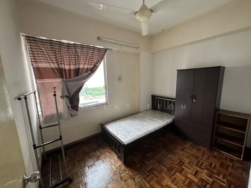Bedroom features: single bed frame, mattress, wooden wardrobe, wooden bookshelf, window with sheer curtains, ceiling fan, parquet wood flooring, painted walls, corner clothing rack; view: city.