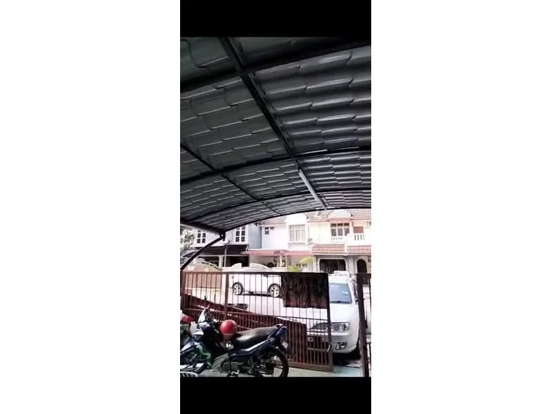 Exterior type: car porch; features: metal roof, open-air structure, space for multiple vehicles, paved driveway, surrounded by fencing, adjacent residential buildings; style: modern.