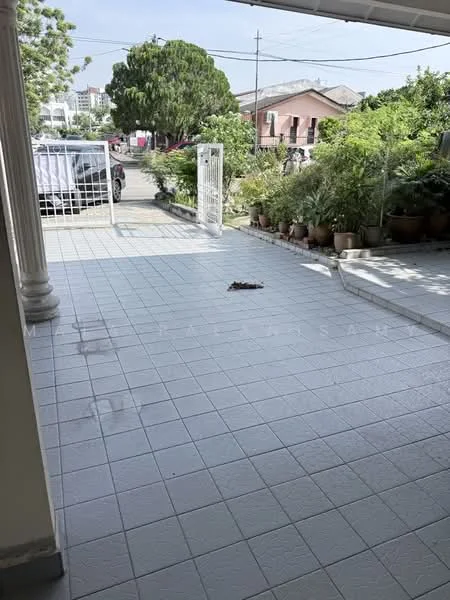Exterior features: tiled flooring, manicured landscaping, potted plants, gate at entrance, driveway, surrounded by greenery.