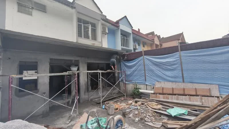 Exterior features: scaffolding, construction materials scattered, partially constructed walls, blue tarp covering, exterior of residential buildings, unfinished landscaping.