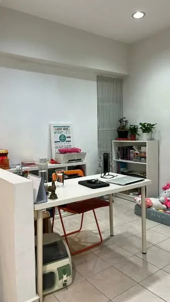Study features: white painted walls, tile flooring, recessed downlights, desk with laptop, orange chair, bookshelves, houseplants, decorative artwork, storage boxes, stuffed animals; style: modern.