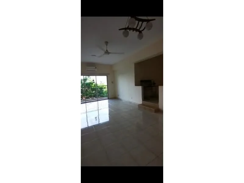 Living features: glossy tile flooring, white painted walls, ceiling fan, sliding glass door, floor-to-ceiling windows, natural light, air conditioning unit, open layout; style: modern; view: garden.