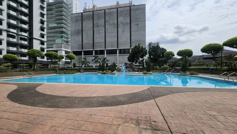 Exterior type: swimming pool deck; features: infinity pool, pool deck with loungers, landscaped garden with manicured shrubs, water fountain feature, surrounding palm trees, paved walkway, tropical landscaping, high-rise buildings in background; style: modern.