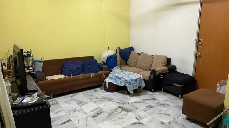 Living features: yellow painted walls, marble tile flooring, 3-seater fabric sofa in brown, 2-seater fabric sofa in beige, coffee table with floral tablecloth, TV console, wall-mounted TV, armchair in brown, decorative cushions, open shelving, door to exterior.