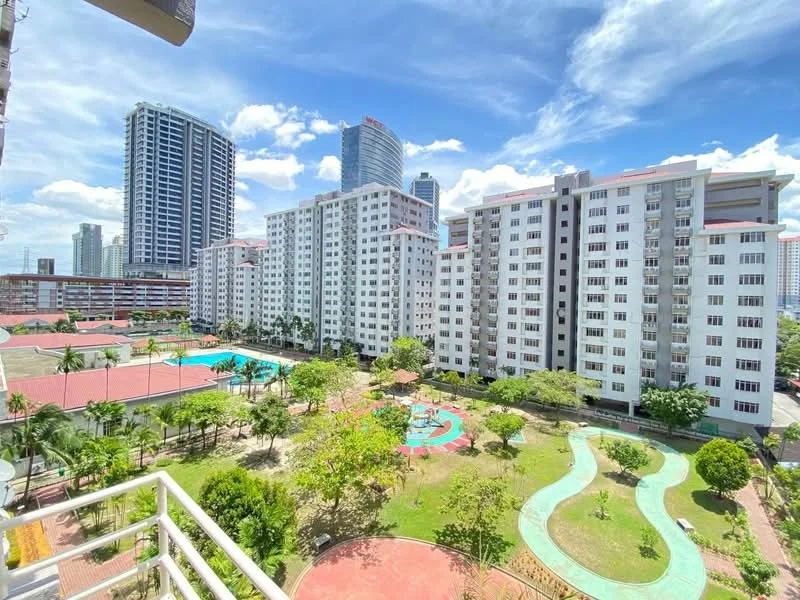 Exterior type: mid-rise condominium; features: multiple residential blocks, swimming pool, landscaped garden, children's playground, walking paths, manicured lawns, surrounded by palm trees, city skyline in background, open-air parking area; style: modern.