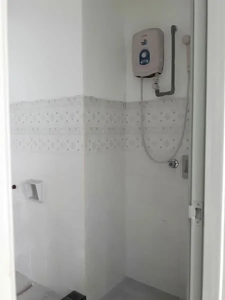 Bathroom features: white tiled walls, grey floor tiles, shower area, water heater, shower head, chrome faucet, toilet paper holder, wall-mounted mirror; style: modern.