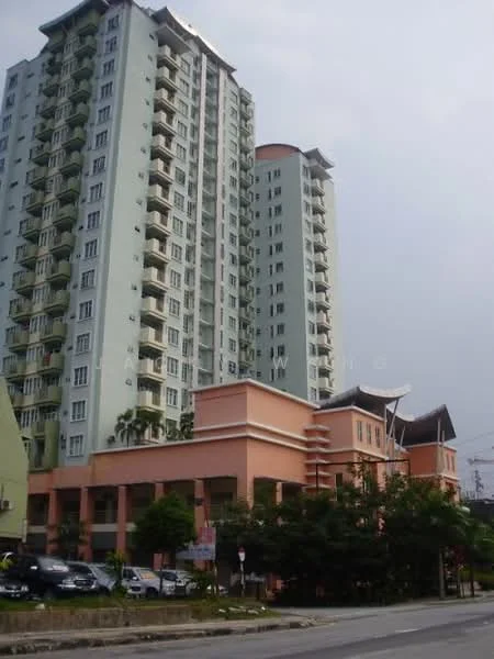 Exterior type: high-rise condominium; features: green painted facade, pink painted facade, balconies on upper floors, multiple storeys, flat roof, surrounded by trees, parking area visible, urban context with road in front; style: modern.