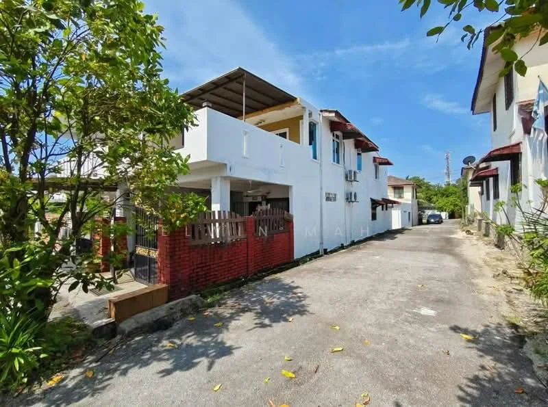 Exterior type: linked terrace house; features: white painted facade, red brick accents, flat roof, two-storey structure, manicured landscaping, driveway with interlocking pavers, surrounded by greenery, adjacent to other residential buildings; style: modern.
