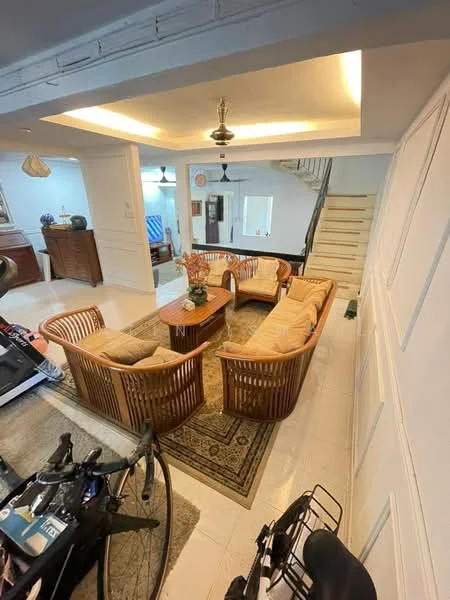 Living features: 3-seater rattan sofa with cushions, 2 armchairs with cushions, wooden coffee table, area rug with geometric pattern, wall-mounted ceiling lights, white painted walls, tile flooring, staircase in background, decorative plants, ceiling fan with light; style: modern.