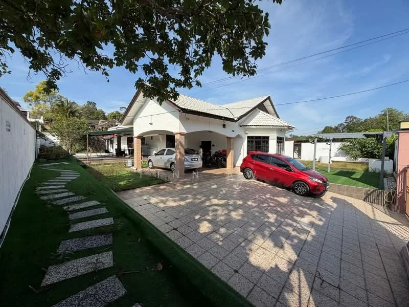 Exterior type: detached bungalow; features: white painted facade, pitched tile roof, manicured lawn, stone-paved walkway, car porch with awning, driveway with interlocking pavers, surrounded by mature greenery; style: modern.