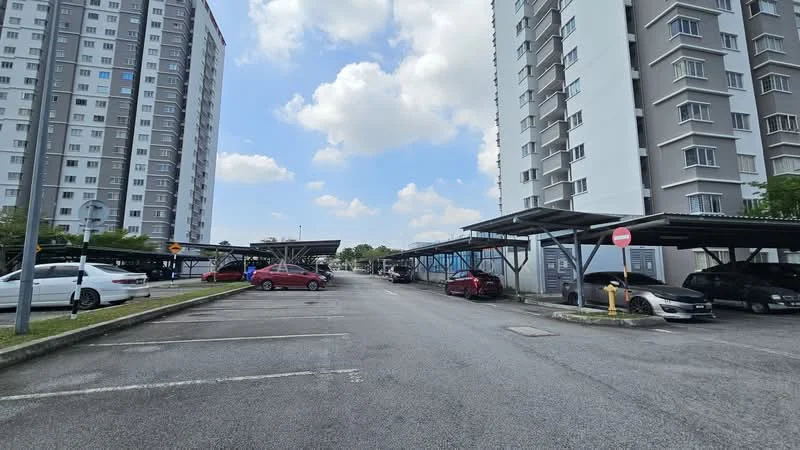 Exterior type: mid-rise condominium; features: covered parking, open-air parking lot, two mid-rise buildings, grey and white facade, street view, manicured landscaping, signage for parking, visible cars in parking area; style: modern.