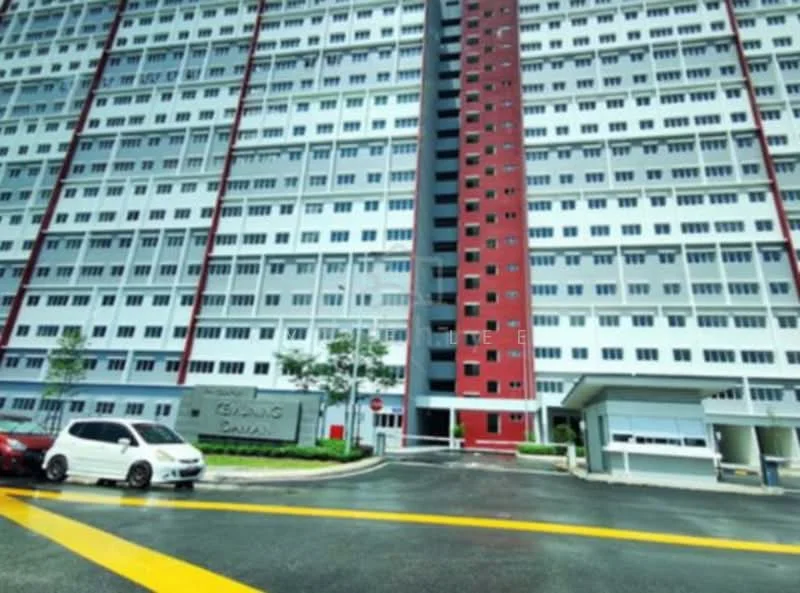 Exterior type: high-rise condominium; features: red and grey facade, glass curtain wall, multiple storeys, landscaped entrance area, driveway with yellow markings, parking area, manicured lawn, trees planted along the entrance; style: modern.
