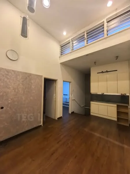 Room features: wooden flooring, white painted walls, high ceiling, recessed downlights, pendant light fixtures, open kitchen area, built-in cabinets, countertop, doorway leading to another room, staircase visible in background; style: modern.