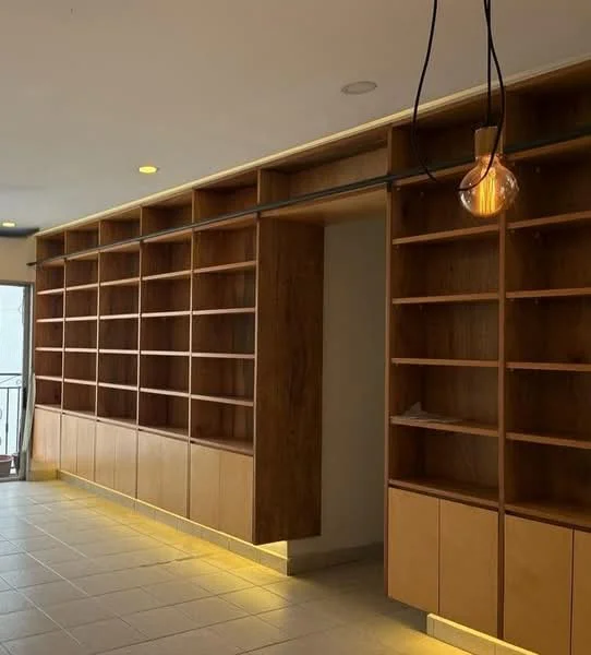 Room features: built-in wooden shelving, open shelving units, light wood cabinetry, recessed lighting, pendant light fixture, tile flooring, neutral wall color, floor-to-ceiling windows; style: modern.