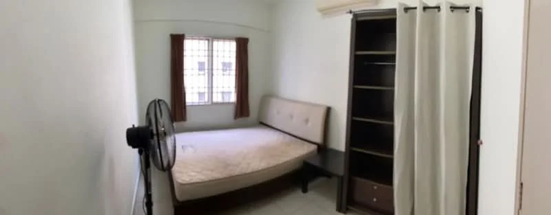 Bedroom features: single bed with beige upholstery, wooden bedside table, built-in wardrobe with shelves, floor-to-ceiling window, brown curtains, ceiling fan, white painted walls, tile flooring.