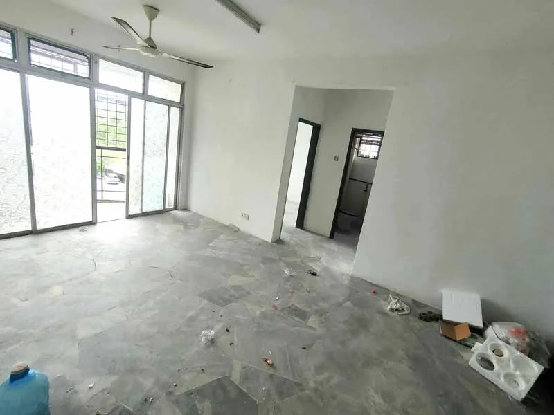 Room features: grey stone flooring, white painted walls, ceiling fan, floor-to-ceiling windows, sliding glass door, open layout, natural light from windows, visible debris on floor.