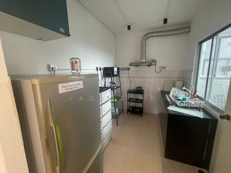 Kitchen features: stainless-steel fridge, built-in cabinets, black countertop, white tiled walls, exhaust hood, sink, kitchen appliances, window with view, floor tiles, light fixture.