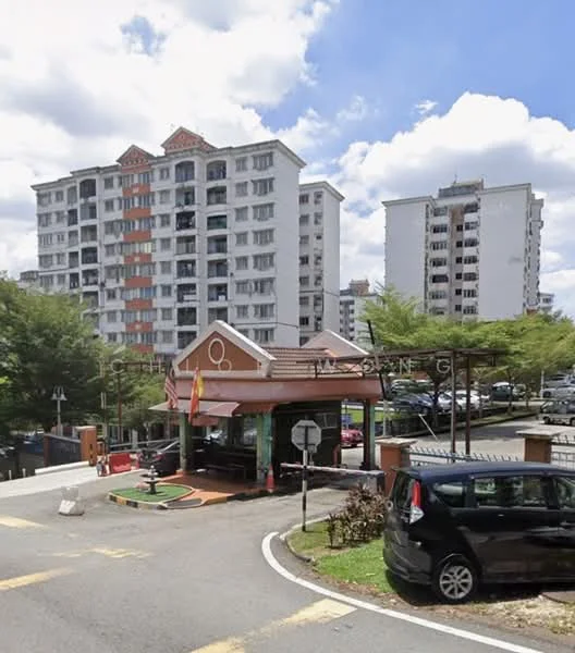 Exterior type: low-rise apartment block; features: white painted facade, balconies with railings, surrounded by greenery, parking area visible, main entrance gate, guard house at entrance; style: modern.
