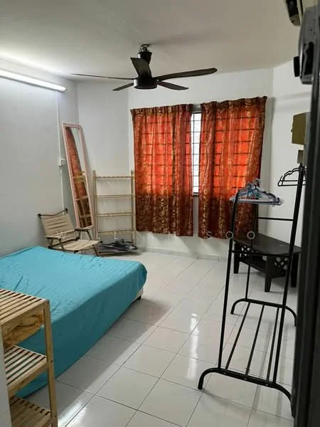 Bedroom features: queen-size bed with turquoise bedding, white tiled flooring, orange patterned curtains, 5-blade ceiling fan, wooden shelving unit, full-length mirror, wooden folding chair, black study desk, clothes rack, window with natural light.