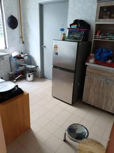 Kitchen features: stainless-steel fridge, wooden cabinetry, countertop with storage, gas stove with 2 burners, ceramic tile flooring, white tiled walls, window with natural light, metal shelving unit, plastic stool.