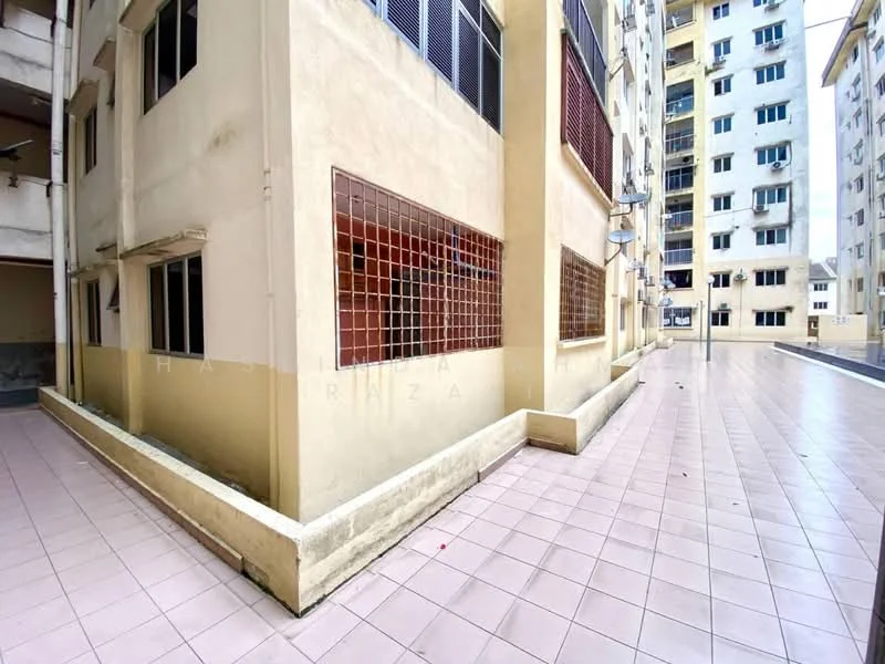 Exterior type: low-rise apartment block; features: cream painted facade, ground-level walkway, tiled flooring, windows with metal grilles, adjacent building structure, open courtyard area; style: modern.