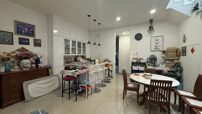 Kitchen features: white cabinetry with flat-panel doors, marble countertop, stainless-steel sink, chrome pull-down faucet, built-in oven, freestanding range oven, refrigerator, pendant lighting, tile flooring, exposed brick wall, dining table with wooden chairs, decorative wall art, ceiling fan, open shelving, wall-mounted clock; style: modern.
