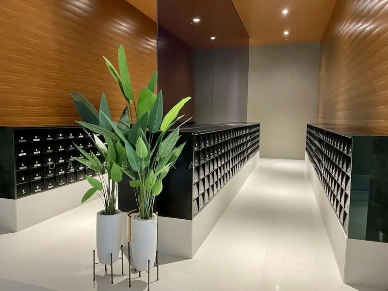 Room features: wood panelled walls, white marble flooring, recessed downlights, black mailboxes, green indoor plants in white pots, modern design, high ceiling, neutral colour scheme; style: modern.