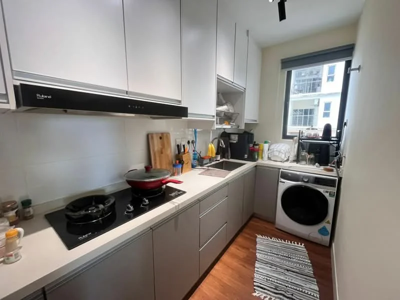 Kitchen features: grey cabinetry, white countertop, black induction cooktop, stainless-steel sink, chrome pull-down faucet, built-in oven, washing machine, window with view, wood laminate flooring, kitchen utensils on countertop, cutting board, decorative rug; style: modern.