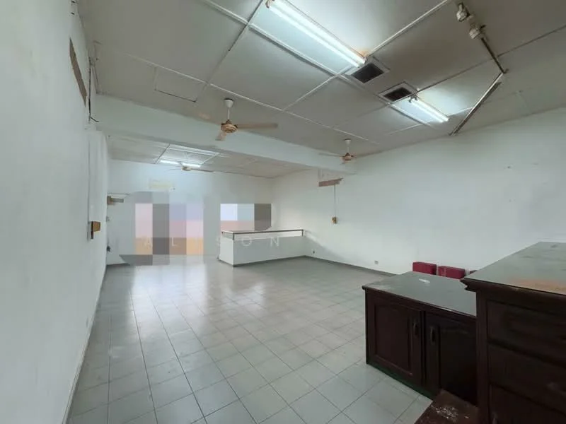 Room features: white painted walls, tile flooring, ceiling with fluorescent lights, ceiling fan, open layout, built-in counter, two red chairs, partition wall, large empty space.