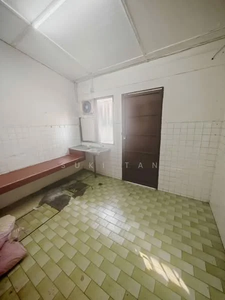 Room features: white painted walls, green ceramic tile flooring, single wall-mounted split AC, brown wooden door, mirror on wall, built-in bench seating, sink with faucet, grout lines visible on tiles.
