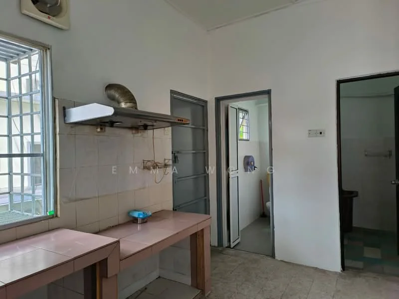Kitchen features: pink tiled countertop, stainless-steel range hood, white tiled walls, grey tiled flooring, single-bowl sink, window with metal grille, doorway to adjacent room, open layout to hallway. Room features: white painted walls, grey tiled flooring, doorway leading to bathroom, window with metal grille.