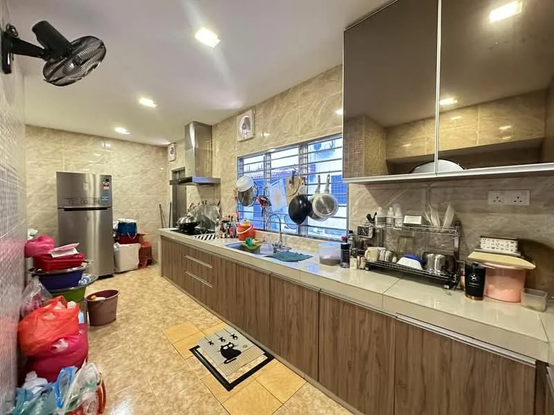 Kitchen features: laminate cabinetry in wood finish, white countertop, stainless-steel sink, chrome pull-down faucet, built-in oven, freestanding fridge, ceramic tile flooring, wall-mounted ceiling fan, window with metal grilles, kitchen utensils hanging, multiple storage containers, decorative rug with pattern; style: modern.