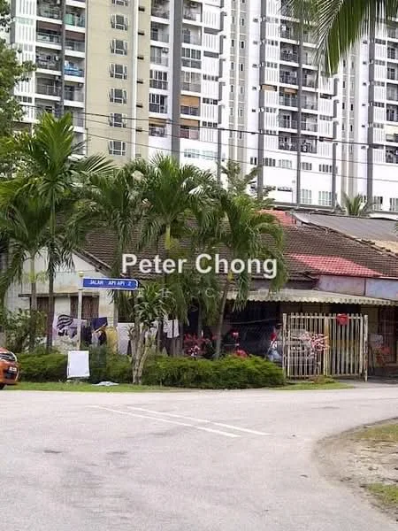 Exterior type: detached bungalow; features: single-storey building, red tiled roof, wooden fence, palm trees, manicured lawn, driveway, street view, adjacent to high-rise buildings; style: traditional.