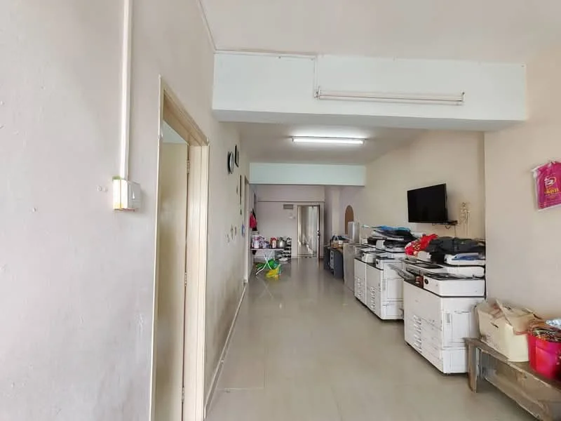 Laundry features: light grey tiled flooring, white painted walls, recessed ceiling lights, wall-mounted TV, multiple washing machines, folding tables, open layout, storage cabinets; style: modern. Room features: light grey tiled flooring, white painted walls, recessed ceiling lights.