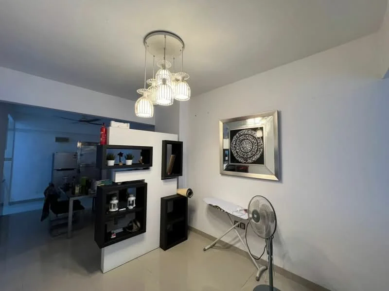 Living features: white painted walls, polished ceramic tile flooring, recessed downlights, 5-blade ceiling fan, modern pendant light fixture, decorative wall mirror, black shelving unit, white shelving unit, ironing board, standing fan; style: modern.