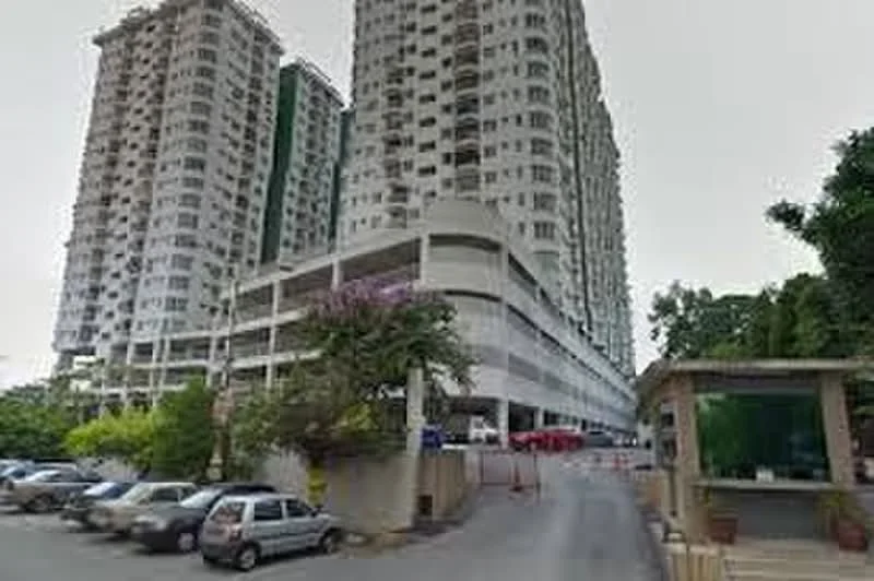 Exterior type: high-rise condominium; features: multi-storey car park, surrounded by greenery, guard house at entrance, gated entry, driveway with interlocking pavers, residential towers with balconies, landscaped garden area; style: modern.
