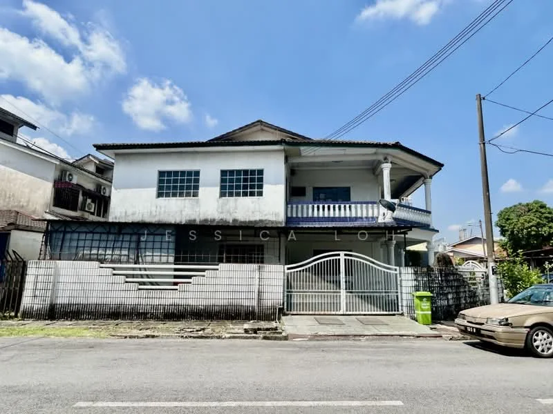 Exterior type: detached bungalow; features: white painted facade, flat roof, two-storey building, recessed balconies, metal gate at entrance, concrete driveway, manicured lawn, surrounded by low fencing, visible air conditioning units, parking space for multiple cars, front porch area; style: traditional.